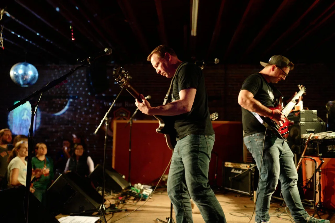 Guitarists shredding live on stage
