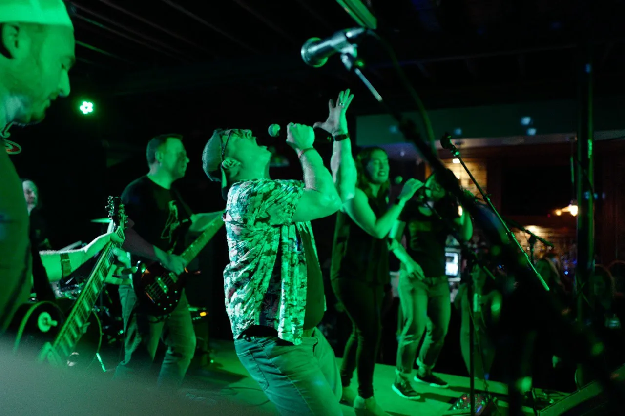 Modesty Shorts performing under green stage lights