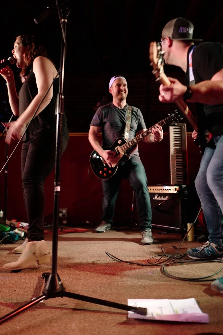 Intimate candid moment on stage during a Modesty Shorts performance